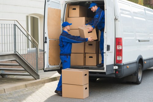 Packed boxes and moving equipment prepared for a small removals service