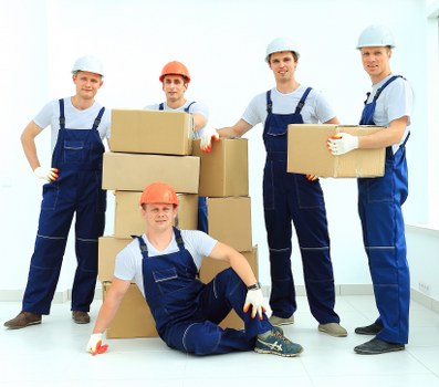 Professional movers carrying items down stairs during a flat removal